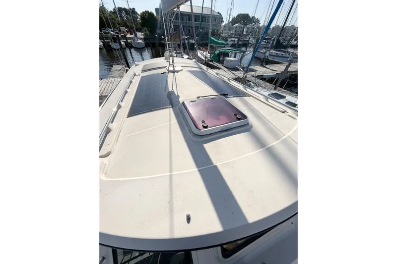 Slide: The Image of 2007 Island Packet SP Cruiser deck view at marina, showcasing sleek design and spacious layout. - 19
