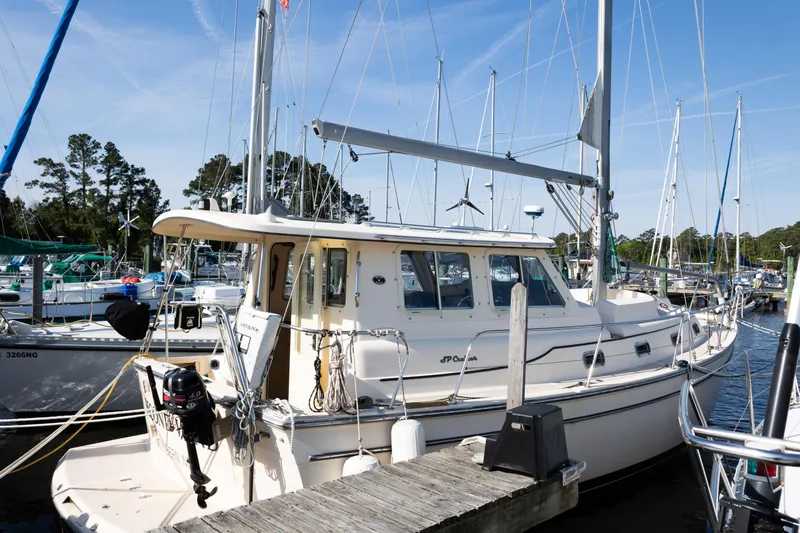 Slide: The Image of 2007 Island Packet SP Cruiser docked at marina under clear blue sky. - 2