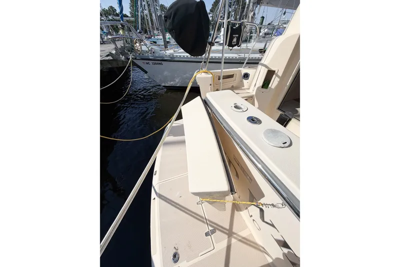 Slide: The Image of 2007 Island Packet SP Cruiser deck view with docked sailboats in marina. - 26