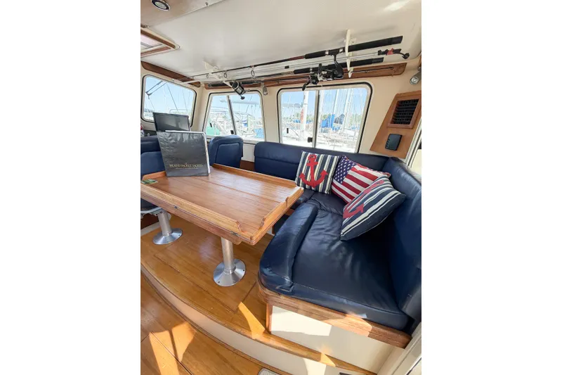 Slide: The Image of Interior of 2007 Island Packet SP Cruiser with blue seating and nautical-themed pillows. - 29