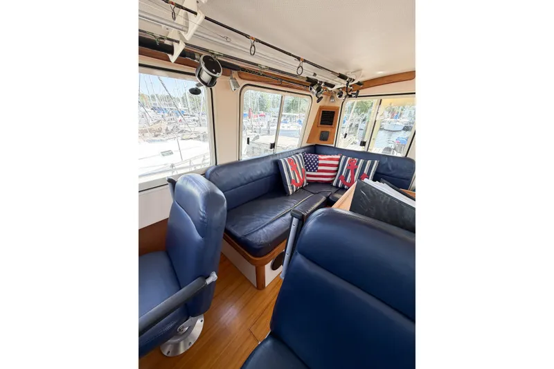Slide: The Image of Interior of 2007 Island Packet SP Cruiser with blue seating and nautical-themed pillows. - 31