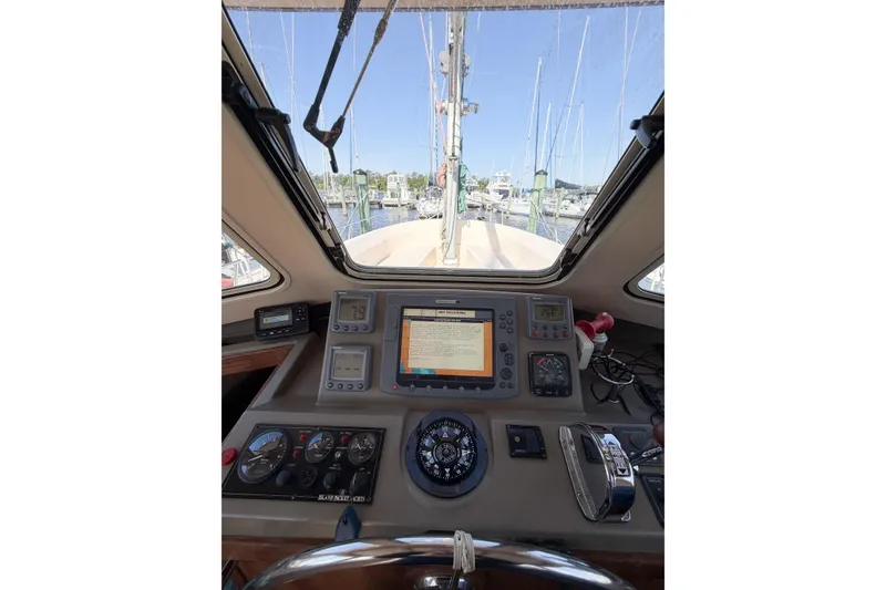 Slide: The Image of Cockpit view of 2007 Island Packet SP Cruiser with navigation instruments and marina backdrop. - 34
