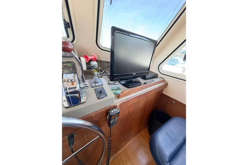 Slide: The Image of 2007 Island Packet SP Cruiser helm with navigation equipment and controls. - 35