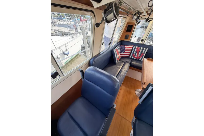 Slide: The Image of Interior of 2007 Island Packet SP Cruiser with blue seating and nautical-themed pillows. - 36