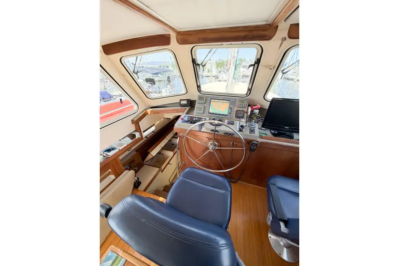 Slide: The Image of 2007 Island Packet SP Cruiser helm with navigation equipment and comfortable seating. - 38
