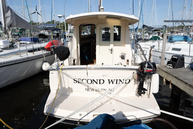 Slide: The Image of 2007 Island Packet SP Cruiser docked, named "Second Wind," in a marina setting. - 4