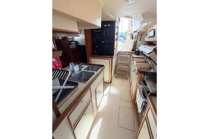 Slide: The Image of Interior view of 2007 Island Packet SP Cruiser's galley with sink and storage. - 43