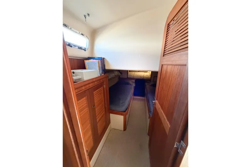 Slide: The Image of Interior cabin of 2007 Island Packet SP Cruiser with wooden finishes and cozy sleeping area. - 48
