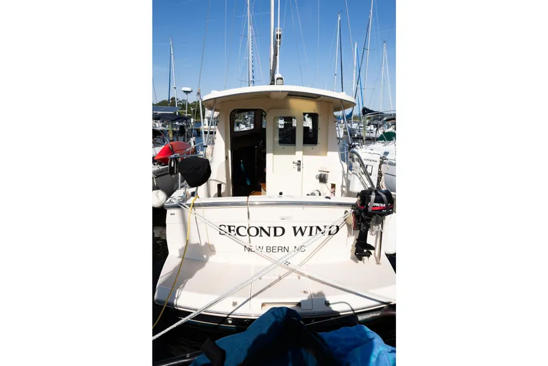 Slide: The Image of 2007 Island Packet SP Cruiser docked, named "Second Wind," in New Bern, NC marina. - 5