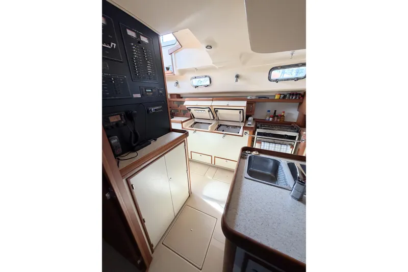 Slide: The Image of 2007 Island Packet SP Cruiser galley with modern appliances and ample storage space. - 53