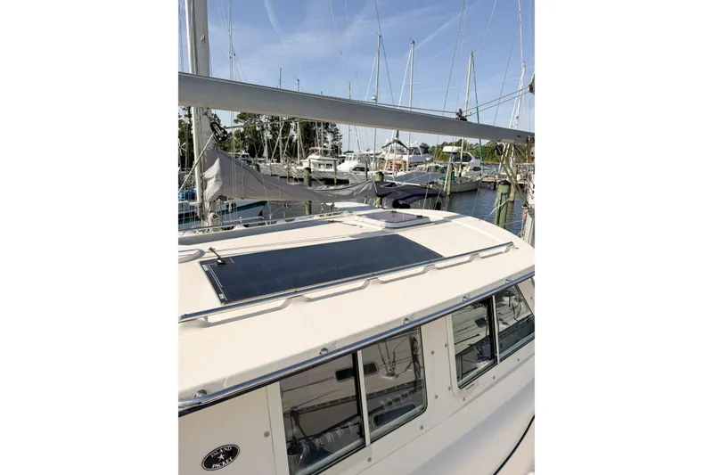 Slide: The Image of 2007 Island Packet SP Cruiser docked, featuring solar panel on cabin roof. - 6