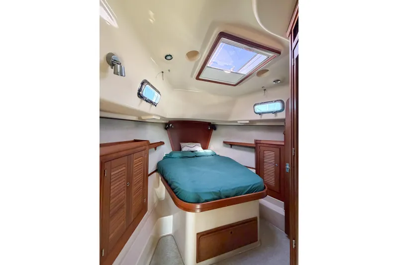 Slide: The Image of Cozy cabin interior of 2007 Island Packet SP Cruiser with skylight and wooden cabinetry. - 61