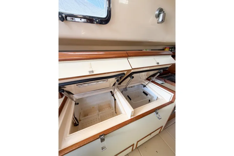 Slide: The Image of 2007 Island Packet SP Cruiser interior with open dual storage compartments. - 64