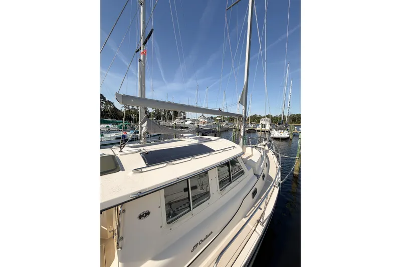Slide: The Image of 2007 Island Packet SP Cruiser sailboat docked in a marina under clear blue skies. - 7