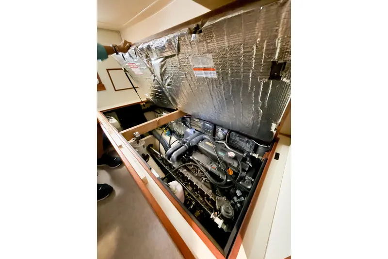 Slide: The Image of Engine compartment of a 2007 Island Packet SP Cruiser sailboat, showcasing detailed mechanics. - 72