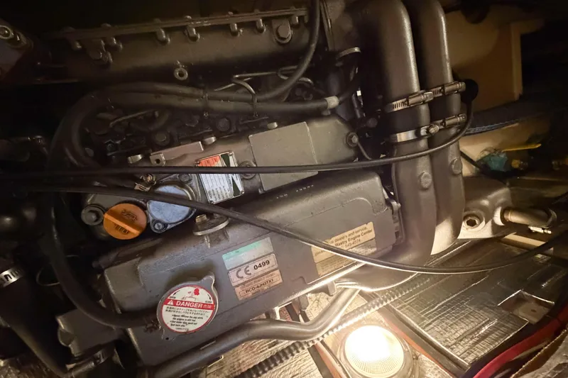 Slide: The Image of Engine compartment of a 2007 Island Packet SP Cruiser, showcasing mechanical components and wiring. - 73