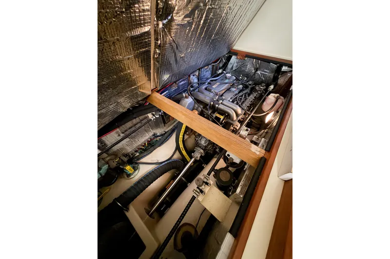 Slide: The Image of Engine compartment of 2007 Island Packet SP Cruiser with visible components and insulation. - 75