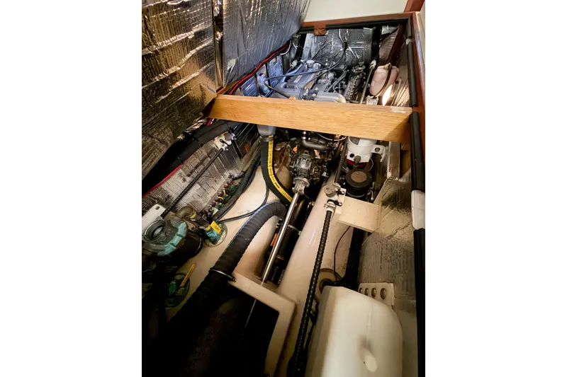 Slide: The Image of Engine compartment of a 2007 Island Packet SP Cruiser, showcasing mechanical components and wiring. - 76