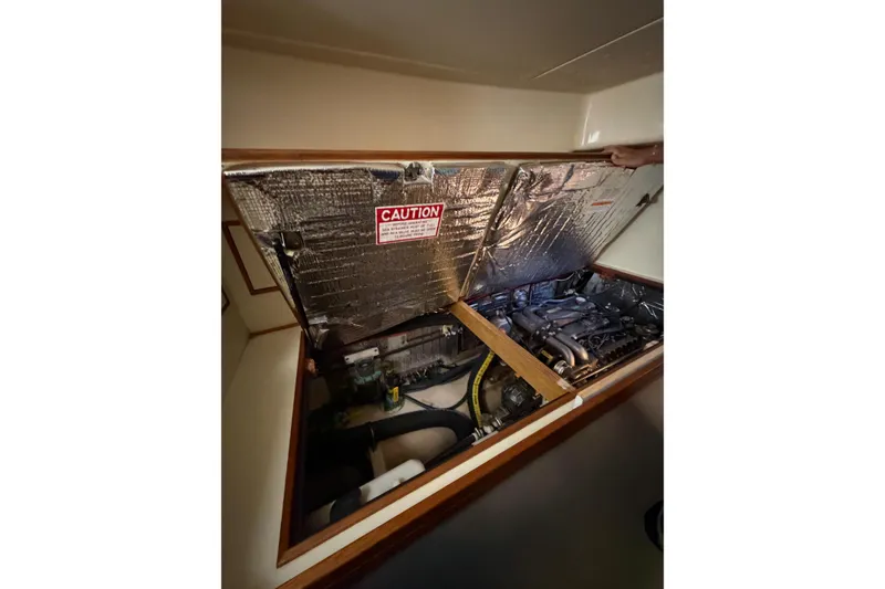 Slide: The Image of Engine compartment of 2007 Island Packet SP Cruiser with insulation and caution label. - 78