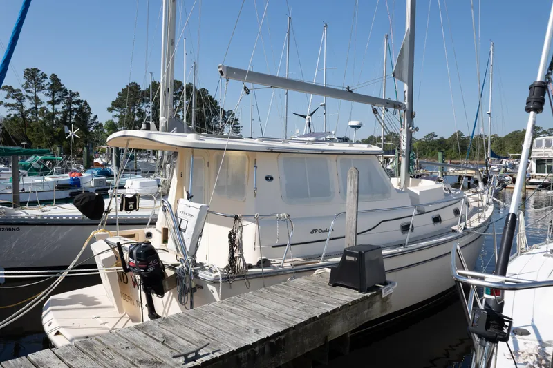 Slide: The Image of 2007 Island Packet SP Cruiser docked at a marina, surrounded by other boats. - 79