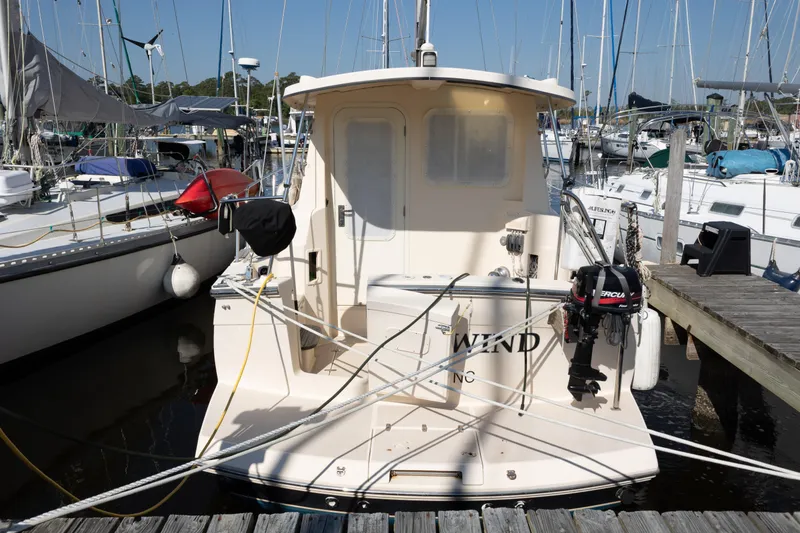Slide: The Image of 2007 Island Packet SP Cruiser docked at marina, surrounded by sailboats. - 80