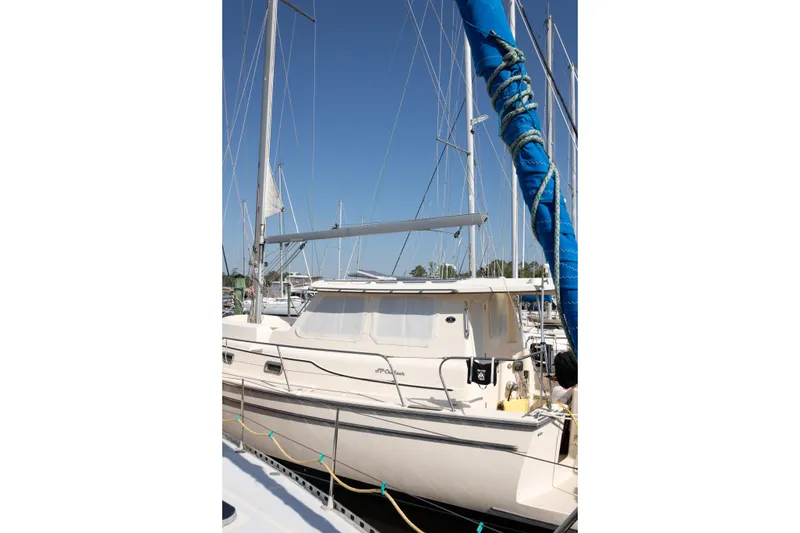 Slide: The Image of 2007 Island Packet SP Cruiser sailboat docked at marina under clear blue sky. - 82