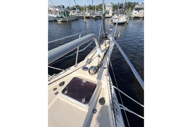 Slide: The Image of 2007 Island Packet SP Cruiser sailboat deck view at marina, showcasing bow and railing. - 9
