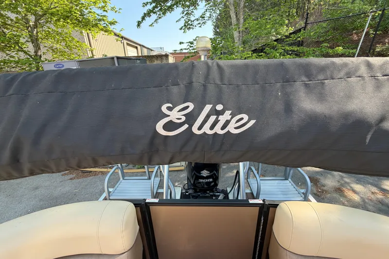Slide: The Image of 2019 Bentley Pontoons 250/253 Elite Admiral with protective cover in outdoor setting. - 11