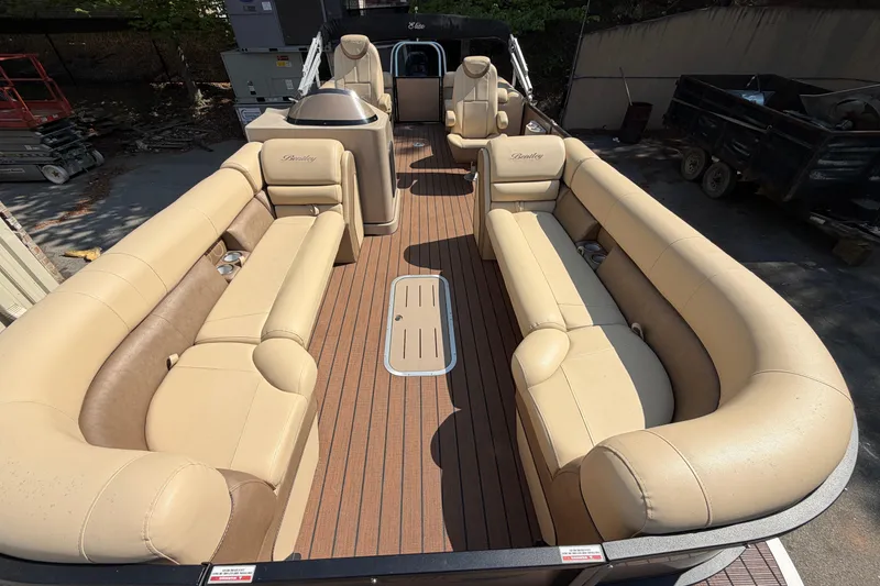 Slide: The Image of 2019 Bentley Pontoons 250/253 Elite Admiral with luxurious beige seating and spacious deck. - 2