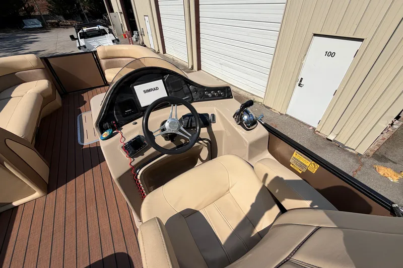 Slide: The Image of 2019 Bentley Pontoons 250/253 Elite Admiral interior with steering console and beige seating. - 4