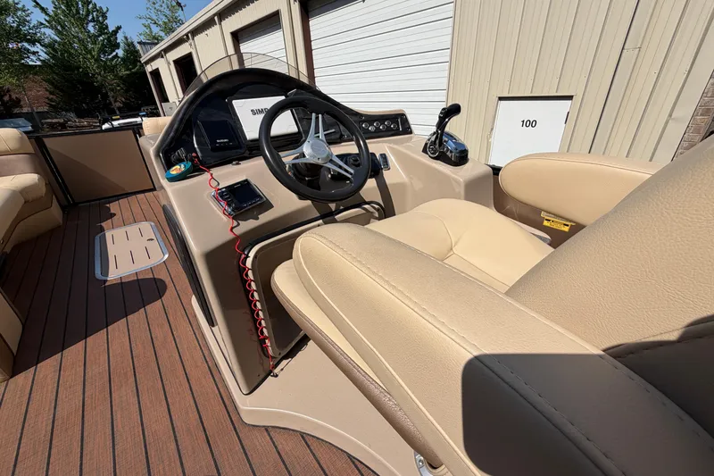 Slide: The Image of 2019 Bentley Pontoons 250/253 Elite Admiral interior with steering wheel and beige seating. - 5