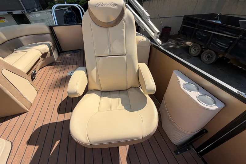 Slide: The Image of 2019 Bentley Pontoons 250/253 Elite Admiral boat interior with beige captain's chair and cup holders. - 6