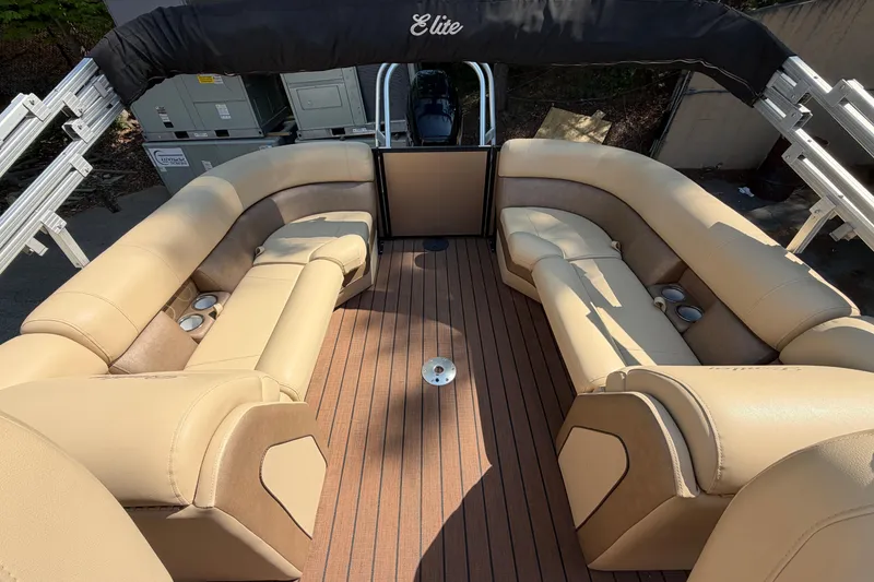 Slide: The Image of 2019 Bentley Pontoons 250/253 Elite Admiral interior with beige seating and wood-style flooring. - 7