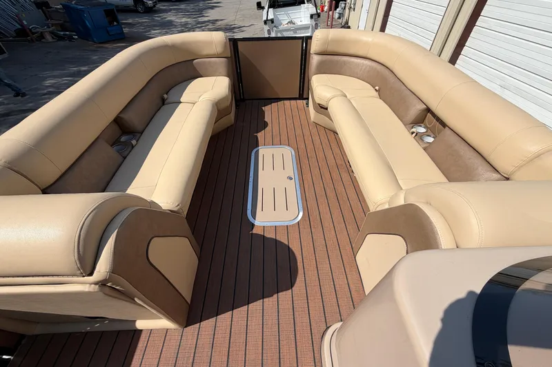 Slide: The Image of 2019 Bentley Pontoons 250/253 Elite Admiral interior with beige seating and wood flooring. - 8