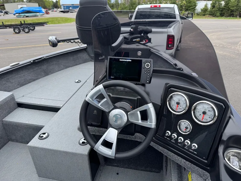 Slide: The Image of Interior view of 2026 G3 Angler V164 C boat with steering and instruments. - 16