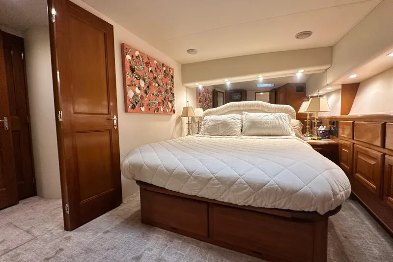 Slide: The Image of Luxurious bedroom interior of a 1997 Viking 58 Convertible yacht with elegant decor. - 101