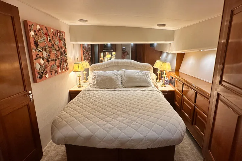 Slide: The Image of Luxurious bedroom interior of 1997 Viking 58 Convertible yacht with elegant decor and lighting. - 103