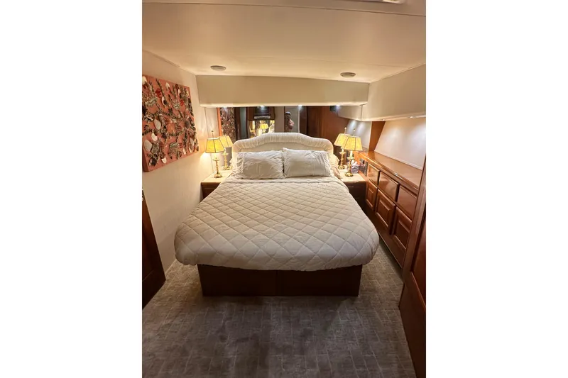 Slide: The Image of Luxurious bedroom interior of 1997 Viking 58 Convertible yacht with cozy bedding and elegant decor. - 104