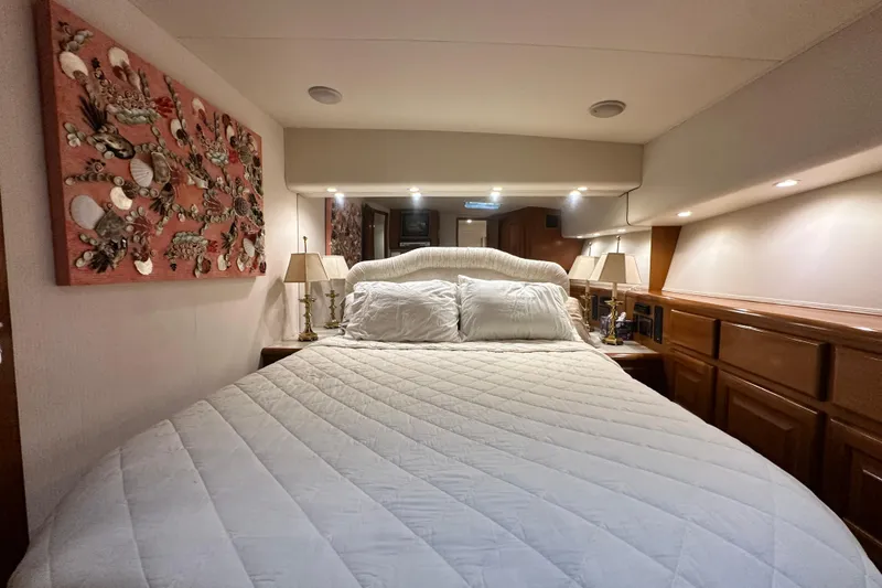 Slide: The Image of Luxurious bedroom interior of 1997 Viking 58 Convertible yacht with elegant decor. - 105