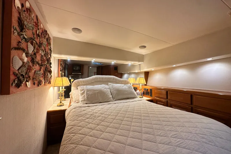 Slide: The Image of Luxurious bedroom interior of a 1997 Viking 58 Convertible yacht with elegant decor. - 106
