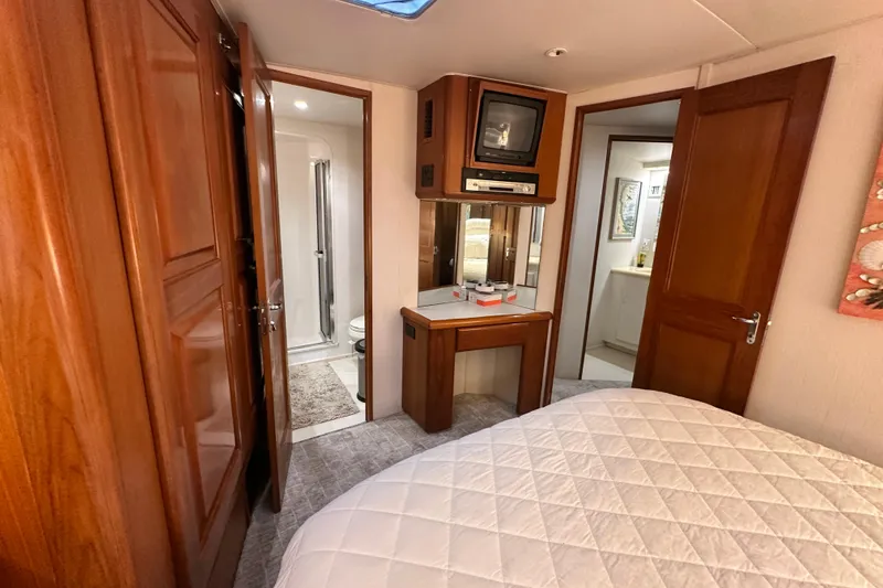 Slide: The Image of Interior of 1997 Viking 58 Convertible yacht with wood paneling and compact bathroom. - 112
