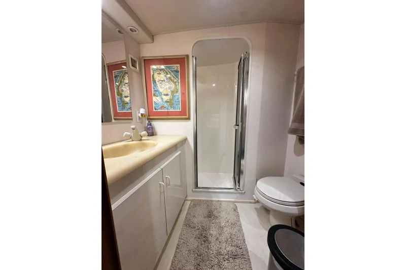 Slide: The Image of Bathroom interior of 1997 Viking 58 Convertible yacht with shower, sink, and toilet. - 113