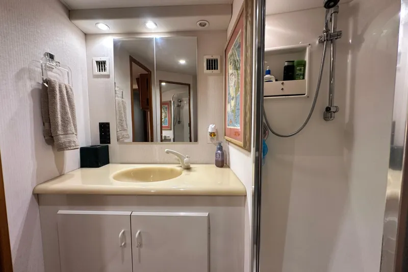Slide: The Image of Bathroom interior of 1997 Viking 58 Convertible yacht with sink and shower. - 116