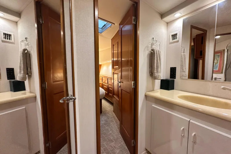 Slide: The Image of Interior of 1997 Viking 58 Convertible yacht, featuring bathroom and hallway with wooden doors. - 117