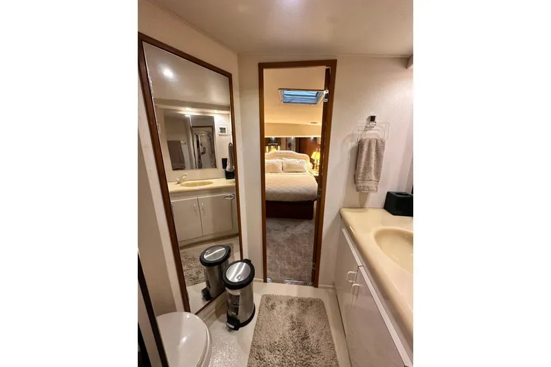 Slide: The Image of Interior of 1997 Viking 58 Convertible yacht, featuring a cozy bedroom and bathroom. - 119