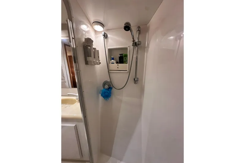Slide: The Image of Shower area in 1997 Viking 58 Convertible yacht, featuring modern fixtures and storage. - 120