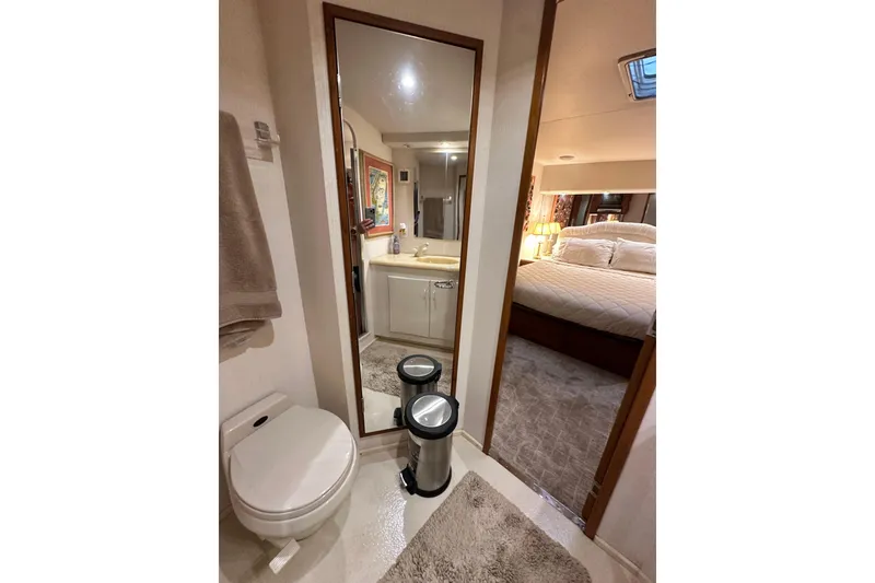 Slide: The Image of Bathroom and bedroom interior of a 1997 Viking 58 Convertible yacht, featuring modern amenities. - 121