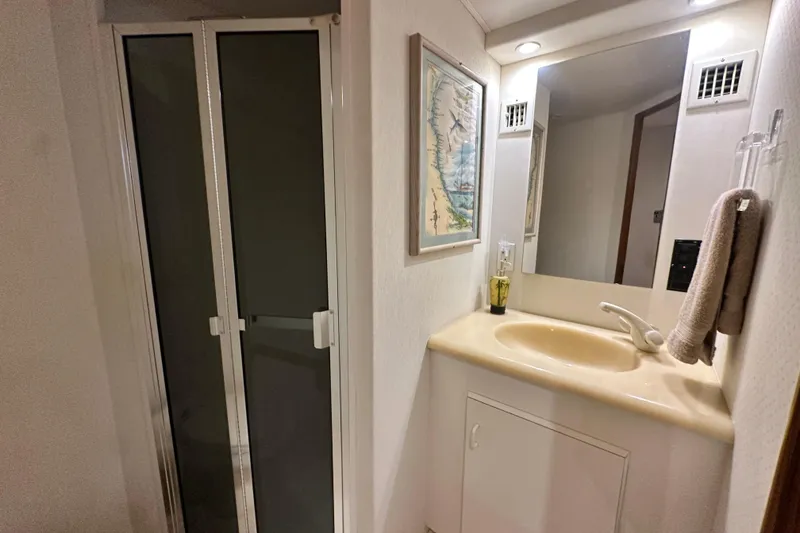 Slide: The Image of Bathroom interior of 1997 Viking 58 Convertible yacht with shower and sink. - 124