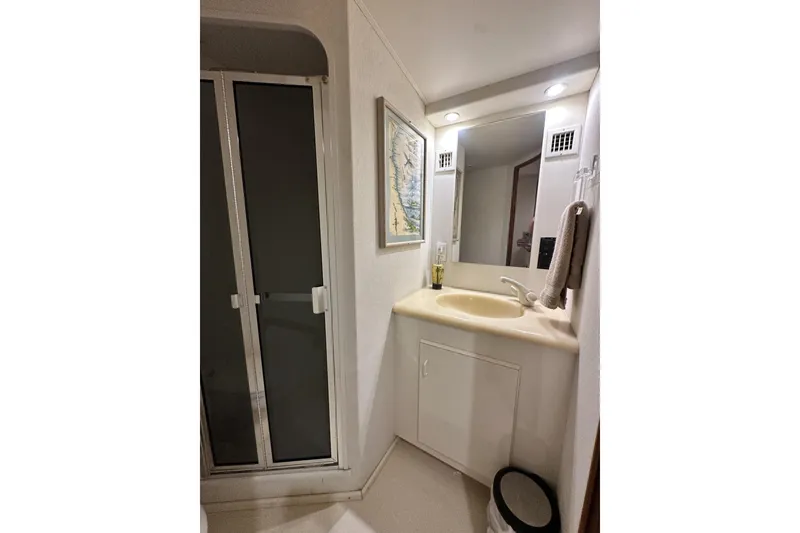 Slide: The Image of Bathroom interior of 1997 Viking 58 Convertible yacht with sink and shower. - 125