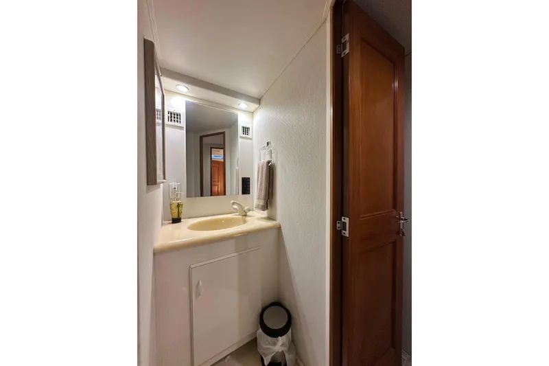 Slide: The Image of Bathroom interior of 1997 Viking 58 Convertible yacht with sink and mirror. - 127